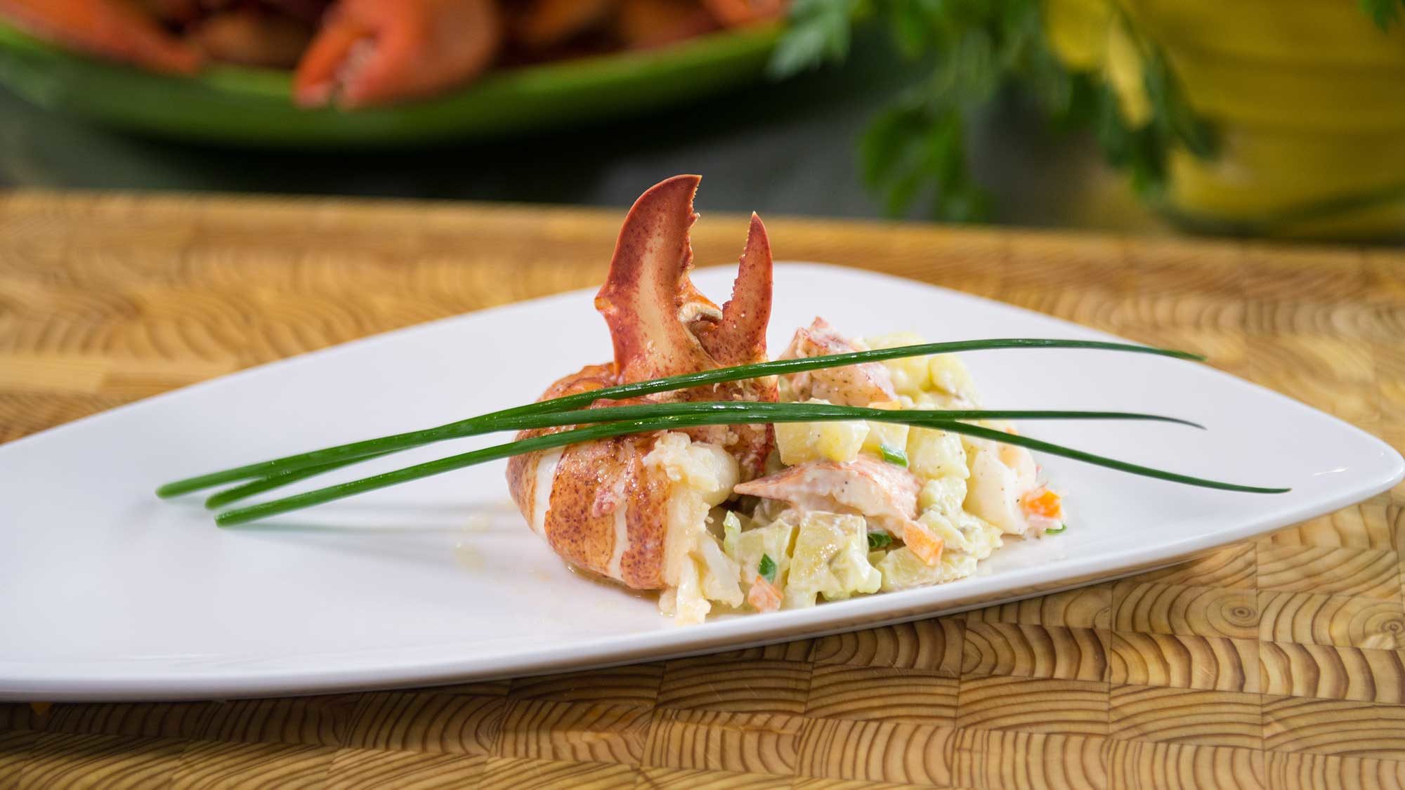plated lobster with candied bacon and potato salad