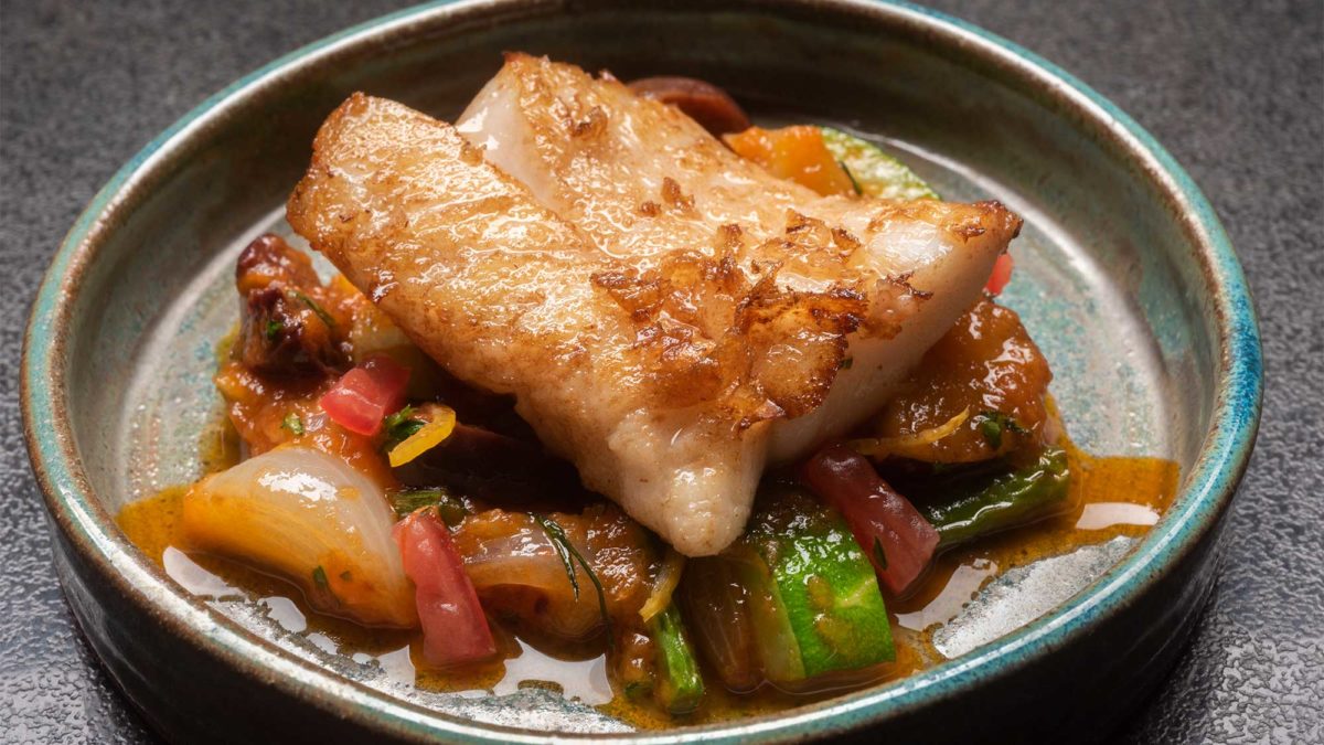 Plated seared redfish with vegetables