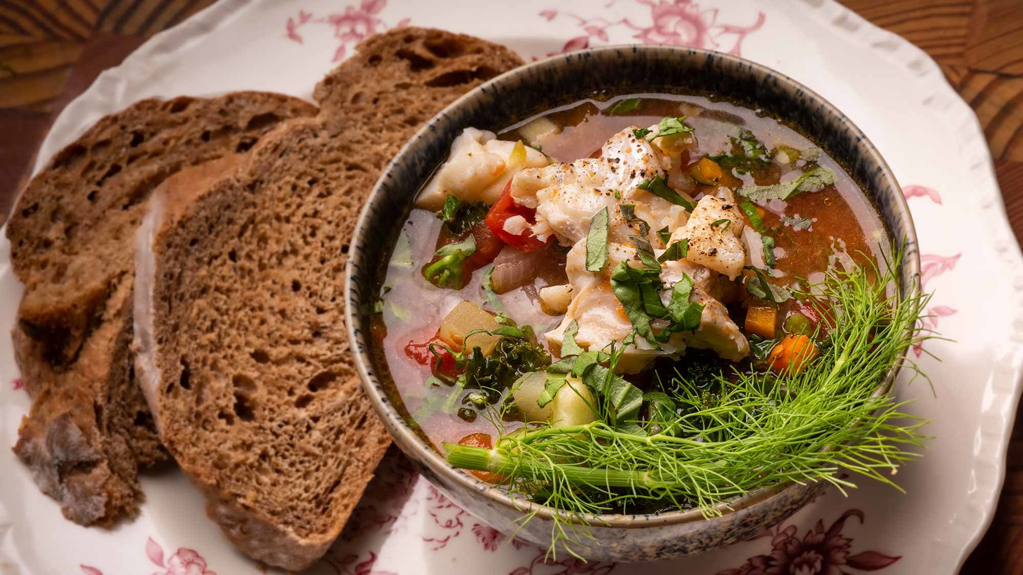 Plated Atlantic Cod and Tomato soup with rye bread